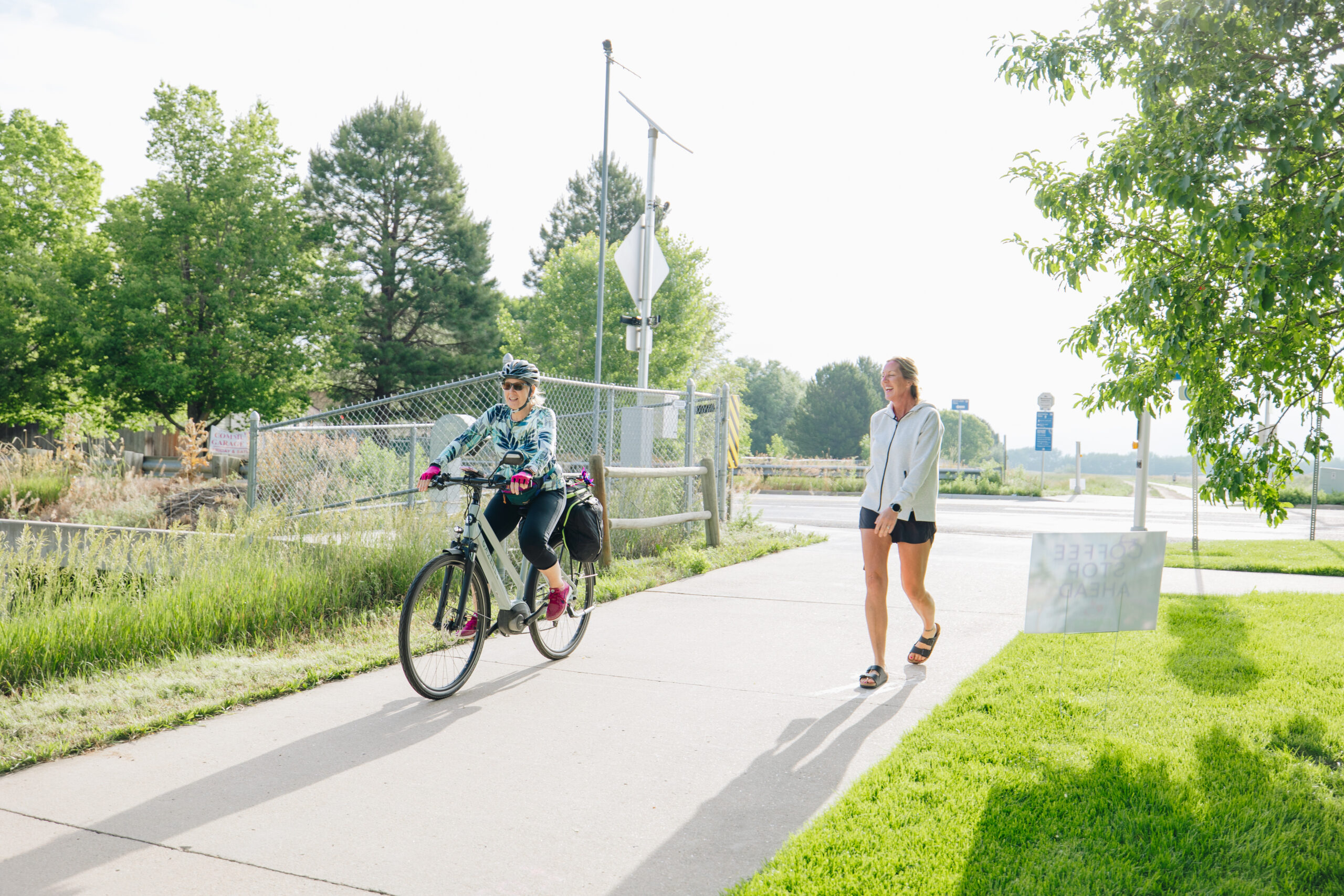 One person riding their bike and one person walking on a trail in Loveland