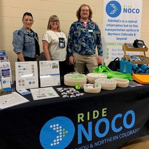 Photo of NFRMPO outreach booth with three MPO staff