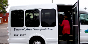 Woman boards a Berthoud Area Transportation System (BATS) shuttle, a demand-response transit service in Berthoud, CO.